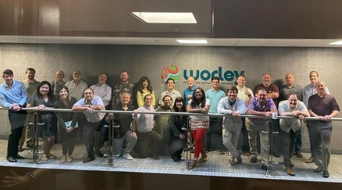 Alcina standing in a large group of Worley people from the Metairie office.