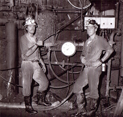 Darryn and another man working in an underground mine.