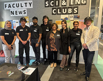 Denzel standing with group of team at curtain career event