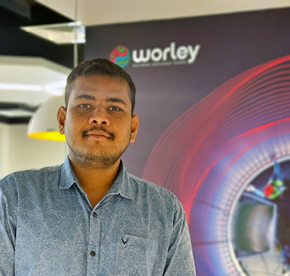 Imran standing in front of a Worley banner.