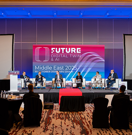 John with 5 others sitting on stage as part of a panel.