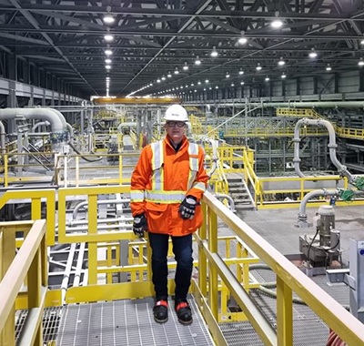 Richard wearing PPE standing inside a Nickel processing plant.