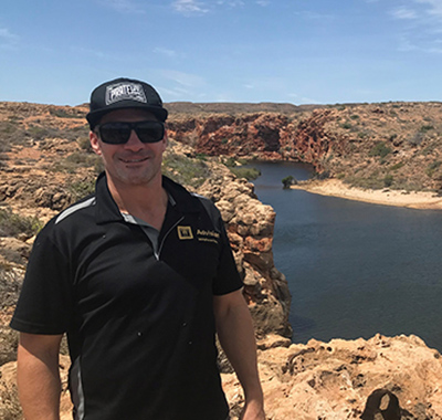 Stuart in the outback near a large body of water.