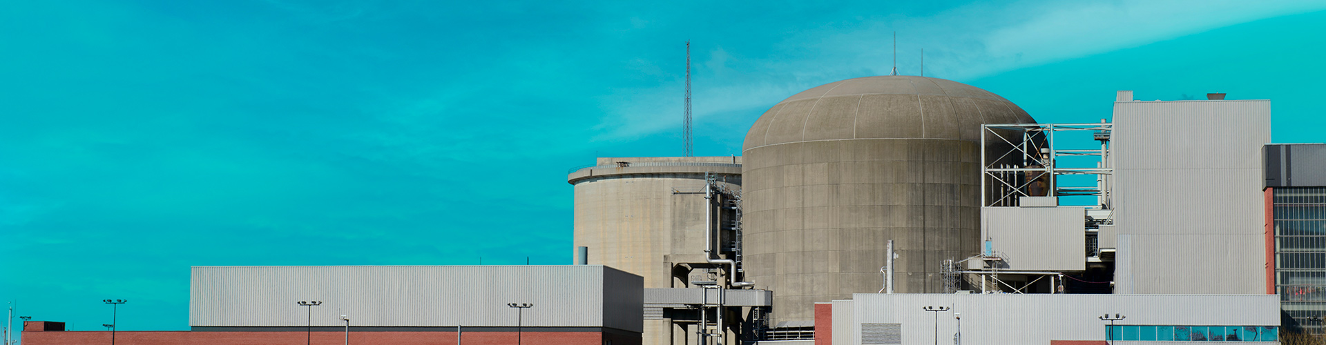 Nuclear power generation station next to a body of water.