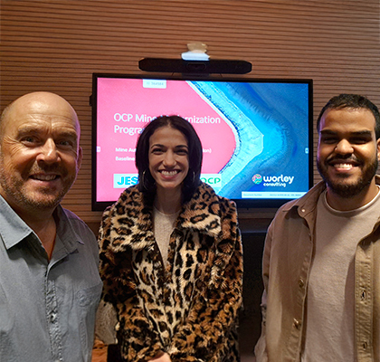 Nick standing with two colleagues from JESA in front of a TV screen.