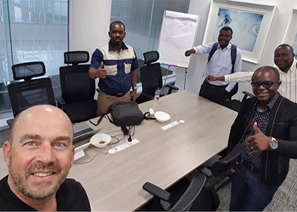 Nick in a meeting room with four colleagues.