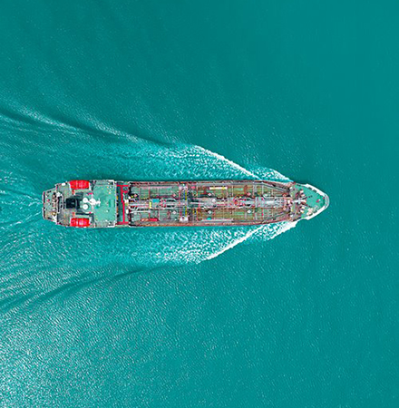 Aerial view of cargo ship sailing on the ocean.