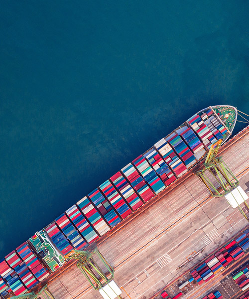 Aerial view of large cargo ship at port.