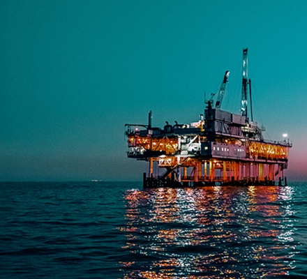Offshore oil platform illuminated by lights.