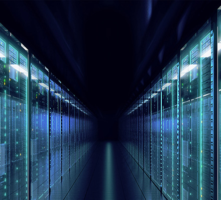 Rows of servers illuminated with lights.