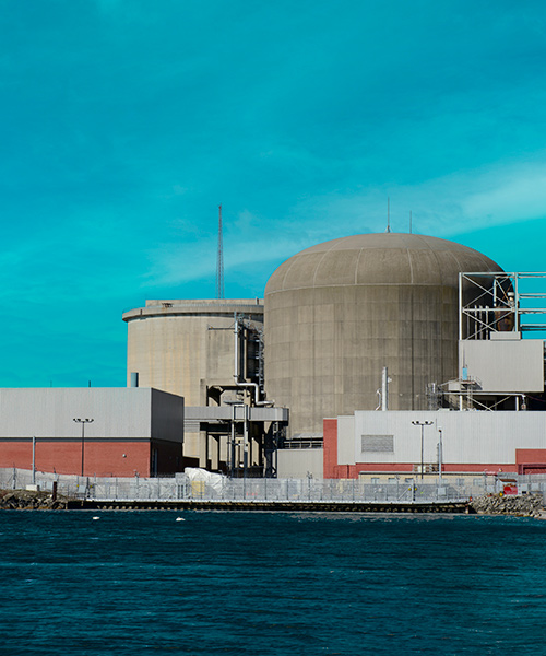 Nuclear power generation station next to a body of water.