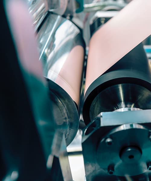 Close-up shot of a machine printing, capturing the moment paper is fed through with fresh ink.