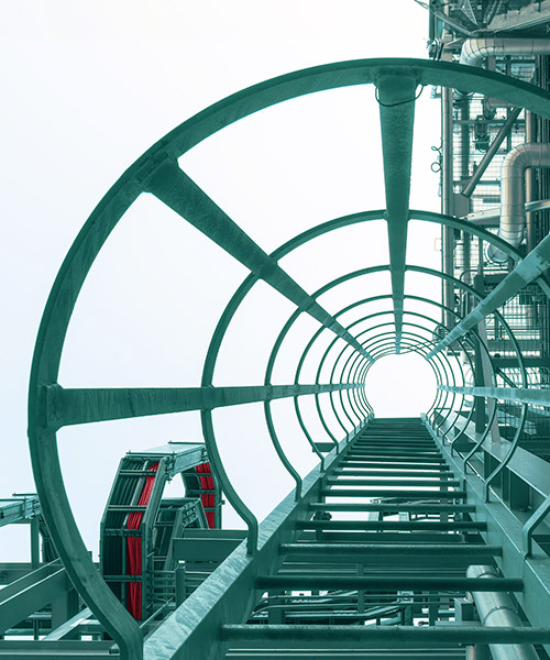 Looking up inside a steel structure with ladder.