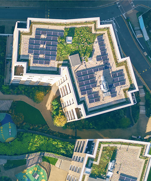 Aerial view of the top of a building with solar panels.