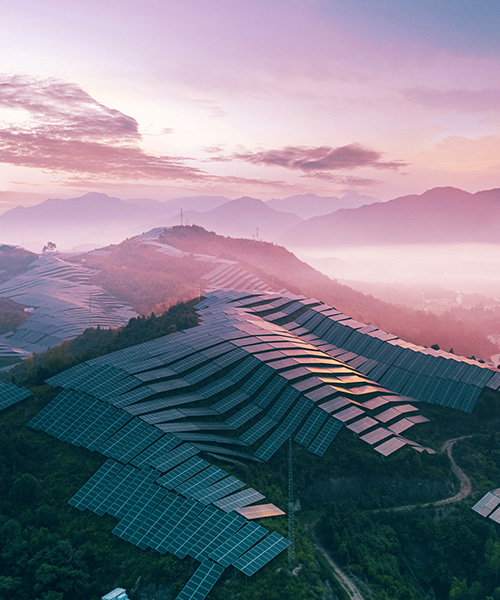 Solar power station on top of mountain range.