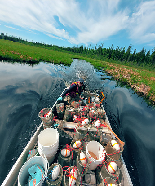 Person travelling through the water on a small motorised boat.