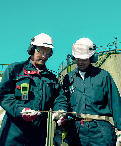 Two workers wearing PPE walking on site together.