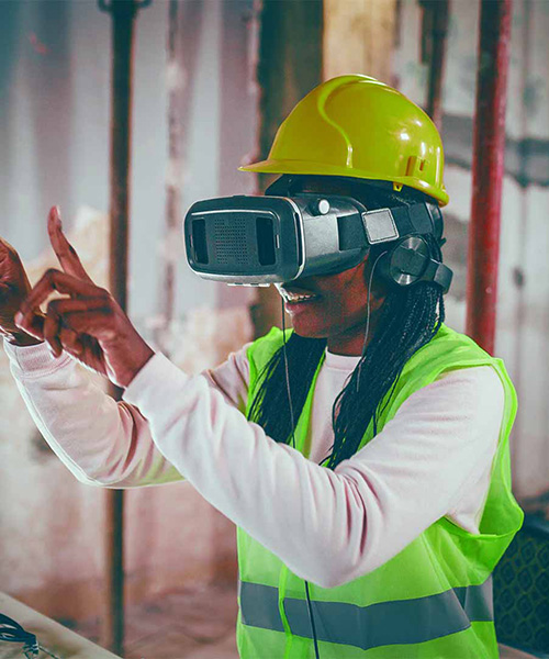 Person wearing a virtual reality headset with their arms out in front of them.