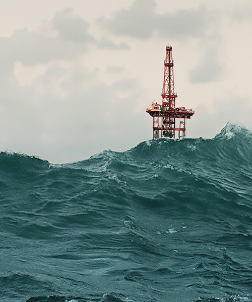Top of an offshore oil platform showing above dark choppy waters.
