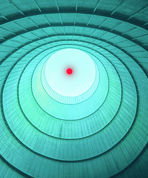 Inside a nuclear cooling tower looking out into the sky.