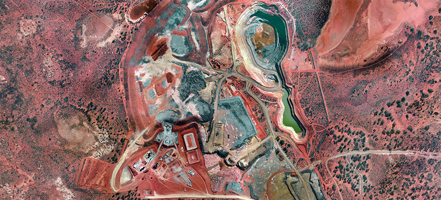 Aerial view of an open-pit mining operation and processing areas.