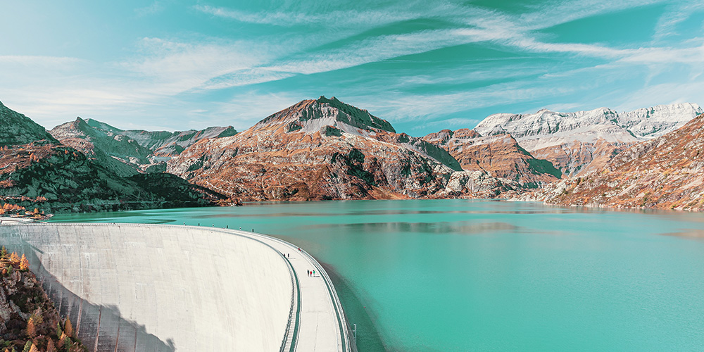 Hydropower plant with mountains in background.