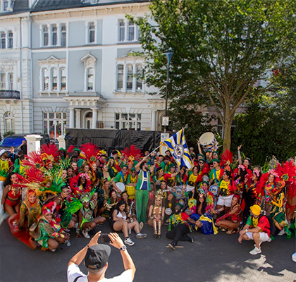 Large group of people dressed in Latin American dancing clothes.