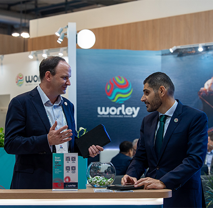 Craig talking with a colleague in the Worley stand at Gastech.