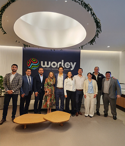 Leandro standing with a group of people inside a Worley office.