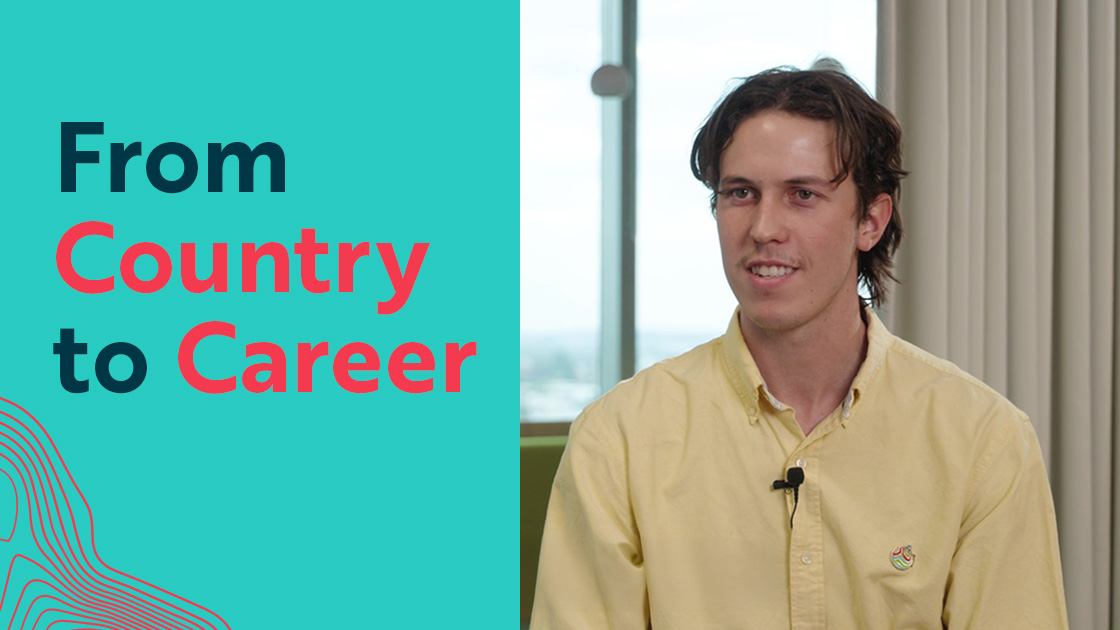 Denzel of Worley sitting inside the office with a microphone on his shirt.