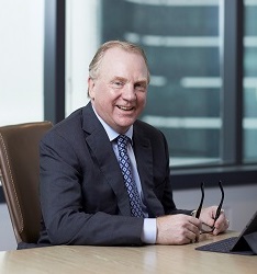 Chris Ashton CEO of Worley sitting at a desk.