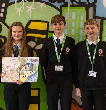 Three students holding the STEM competition award.