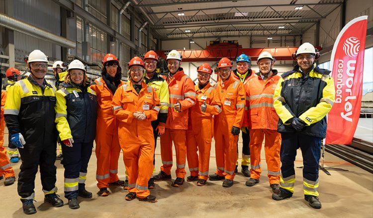 Group of people wearing protective clothes and helmets, standing together at Worley Rosenberg.