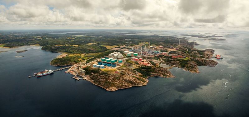 Aerial view of Lysekil refinery next to water.