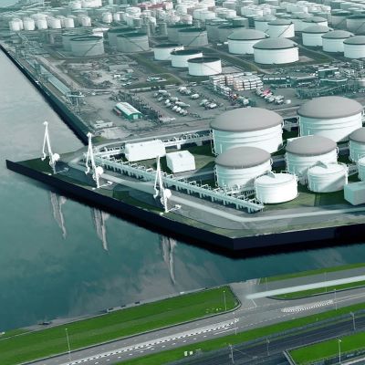 Aerial view of storage tanks on water.