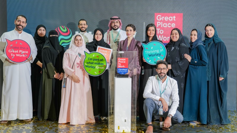 Group of Worley people from the Saudi Arabia office standing together with signs.