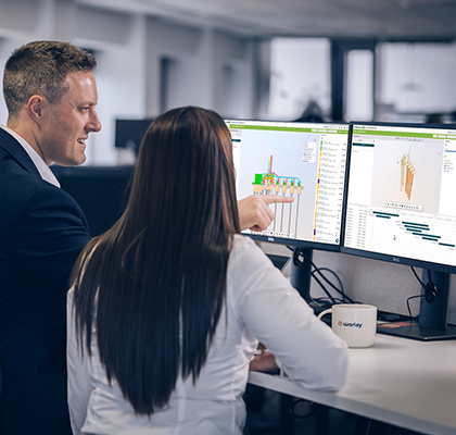 Two Worley people standing in front of screens displaying O3 tool.
